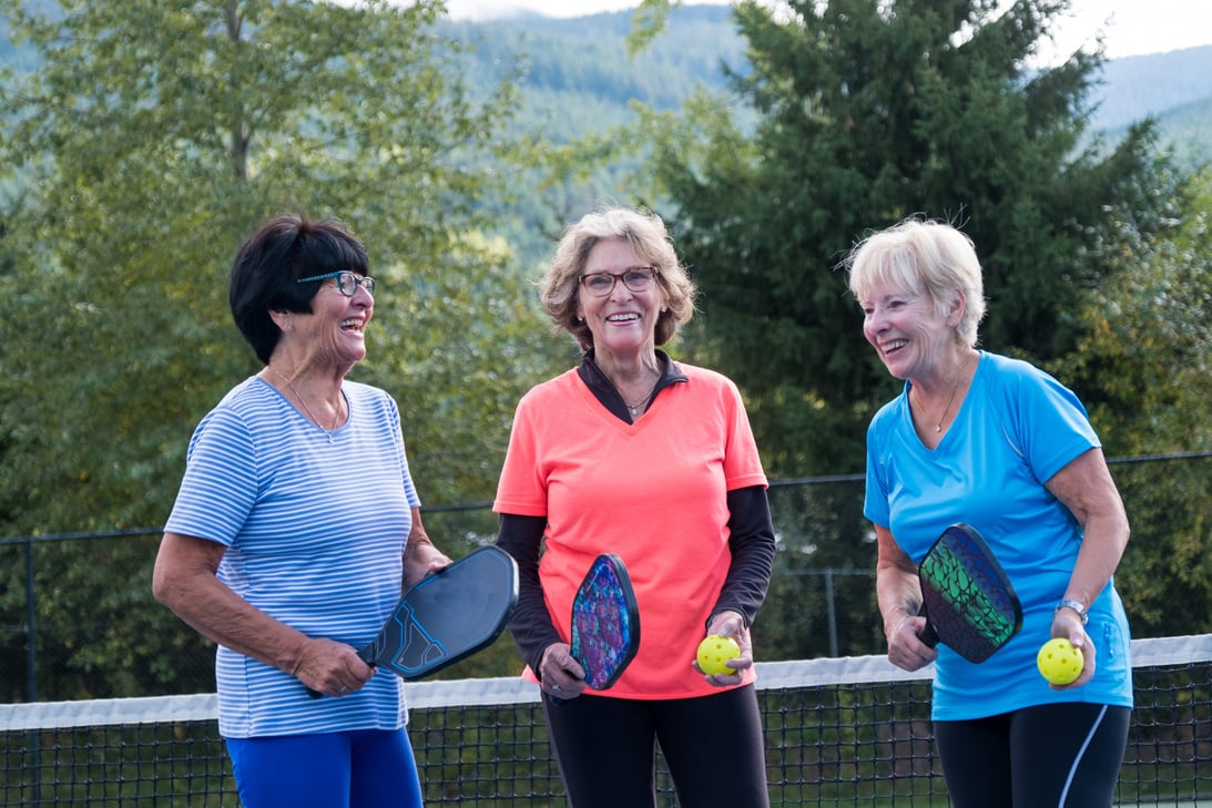 Active seniors bonding at the tennis court